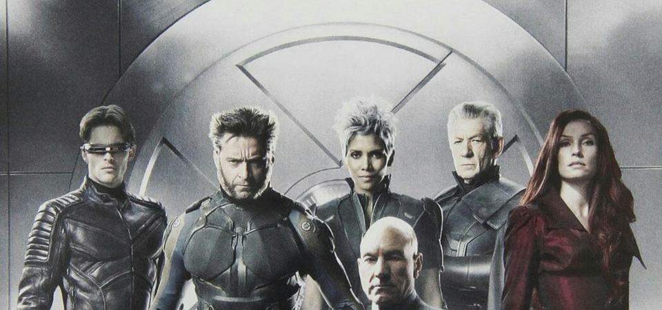 Jean Grey standing amid the X-Men, backlit in a wide cinematic shot