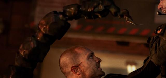 A possessed Mac Gargan wielding Scorpion's mechanical stinger tech during an attack on a Damage Control facility